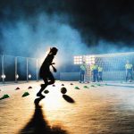 Girls playing soccer at night