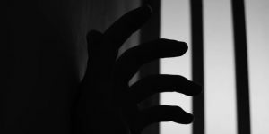 A hand and barred window
