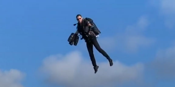 A man flies with a jetpack