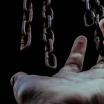 A hand reaches for chains