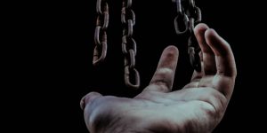 A hand reaches for chains