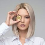 A woman with a bitcoin over her eye