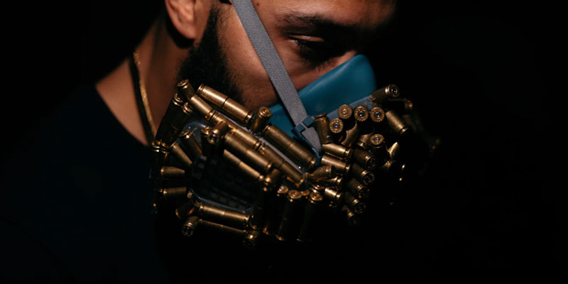 A man with a bullet mask