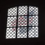 American flag behind a barred window