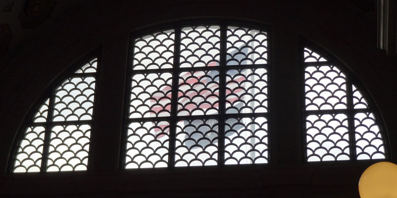 American flag behind a barred window