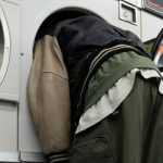 A man with his head in a washing machine