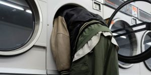 A man with his head in a washing machine