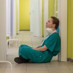 A nurse sitting in a doorway