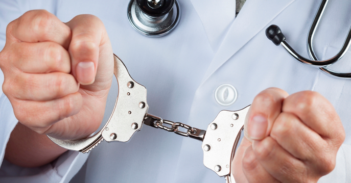 Doctor or Nurse in Handcuffs Wider