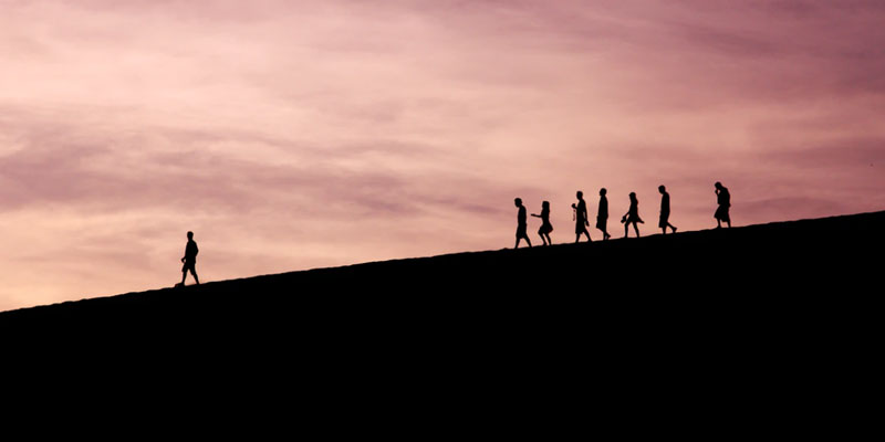 Silhouette of hikers with leader