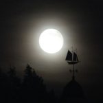 The moon over a weathervane