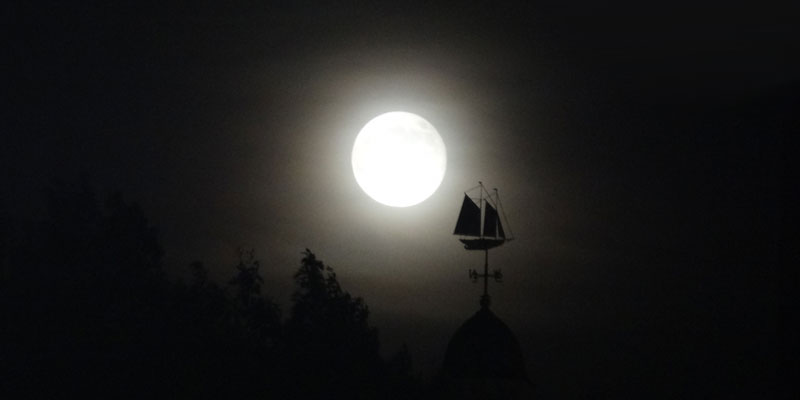 The moon over a weathervane