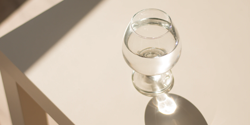 Water glass on beige table