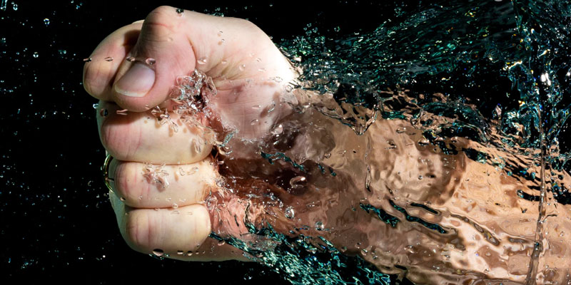 A fist punches water