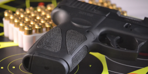 A handgun, bullets, and target
