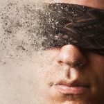 A blindfolded man disintegrating