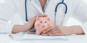 Doctor covers a piggy bank