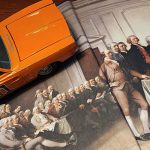 Toy General Lee car drives up a book open to be a ramp