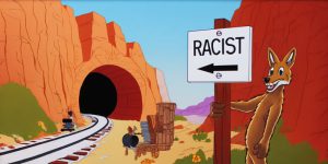 A coyote sets a trap with a fake tunnel and "Racist" sign